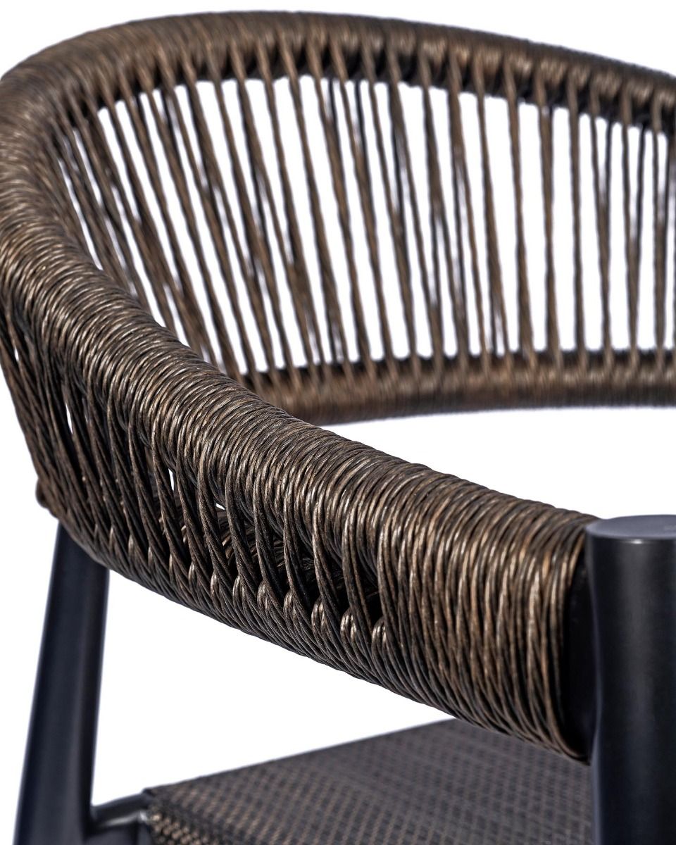 Close-up of a wicker chair with a dark metal frame
