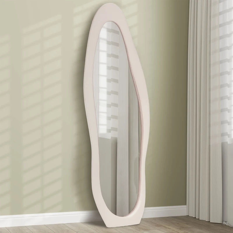 Elongated floor mirror with a white frame on a beige wall.