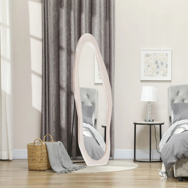 White oval mirror leaning against a wall in a bedroom setting.