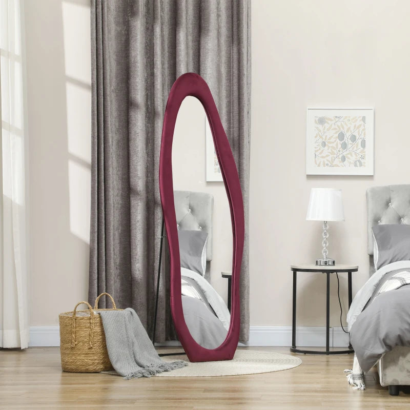 Oval mirror with burgundy frame in a bedroom setting