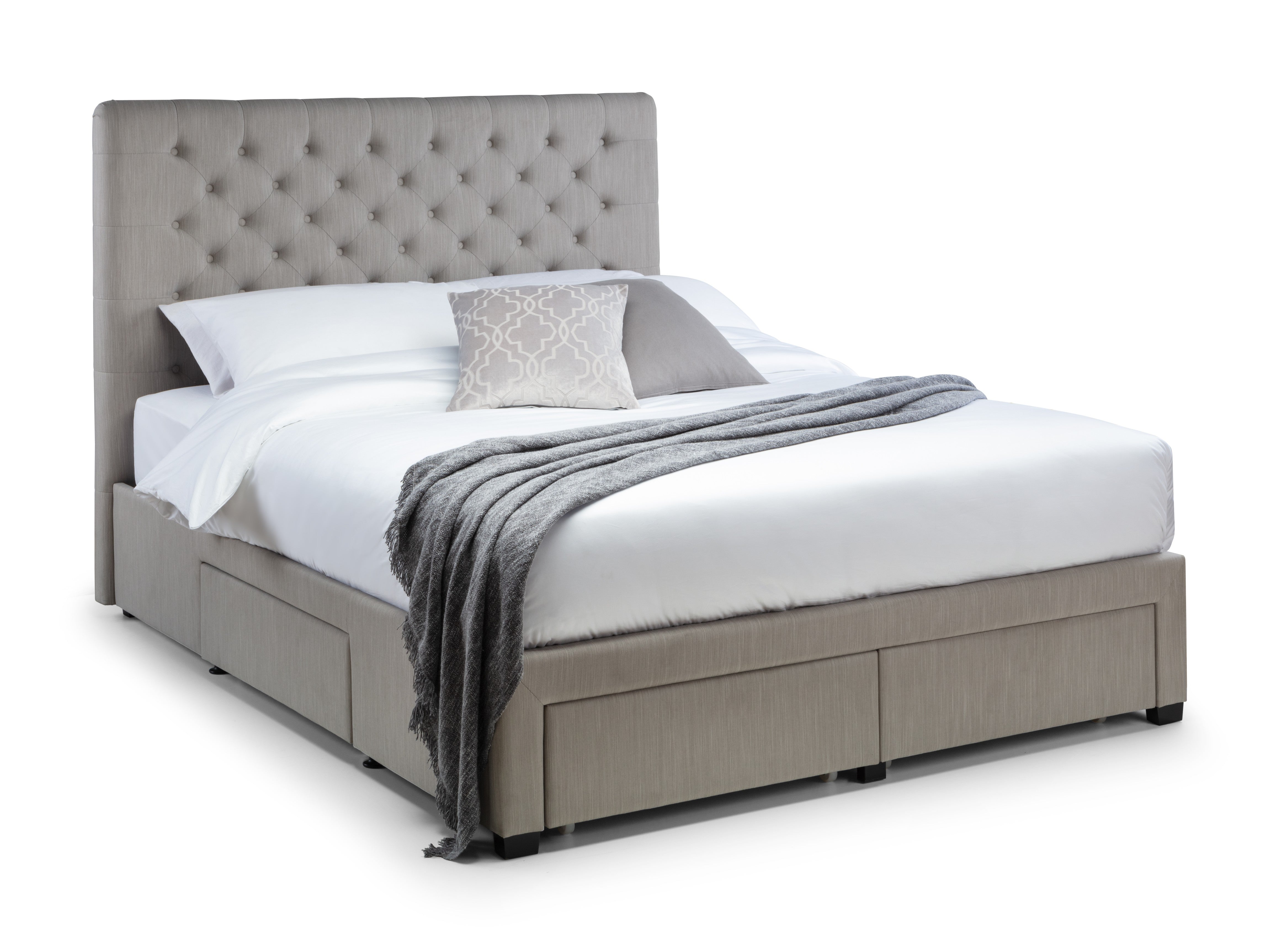 Gray upholstered bed with white bedding and gray blanket on a white background