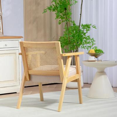 Wooden chair with wicker backrest in a room with a plant and side table.