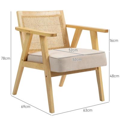 Wooden armchair with wicker backrest and beige cushion, shown with dimensions on a white background.