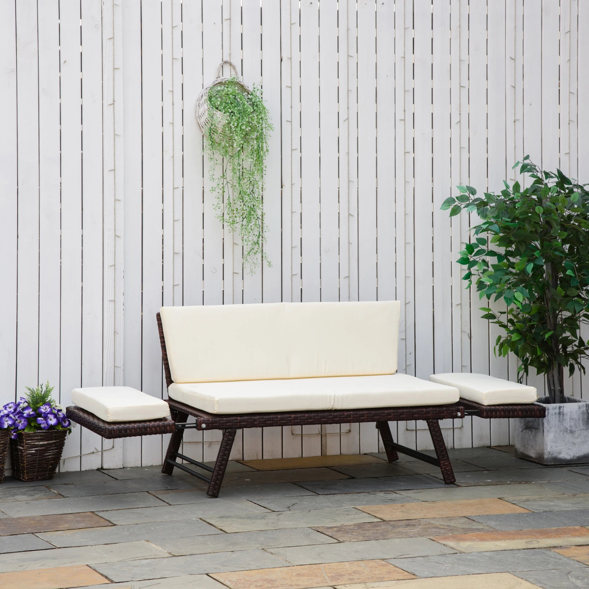 Outdoor patio set with beige cushions against a wooden wall.